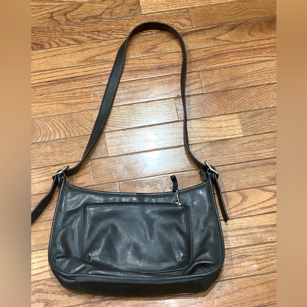 Fossil black leather adjustable shoulder bag with brushed silver buckles.
